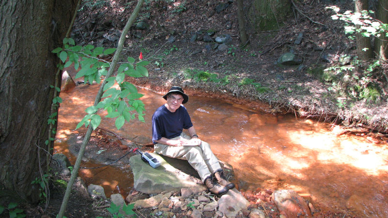 Tom Bott, Ph.D. monitoring a stream contaminated by acid mine drainage.