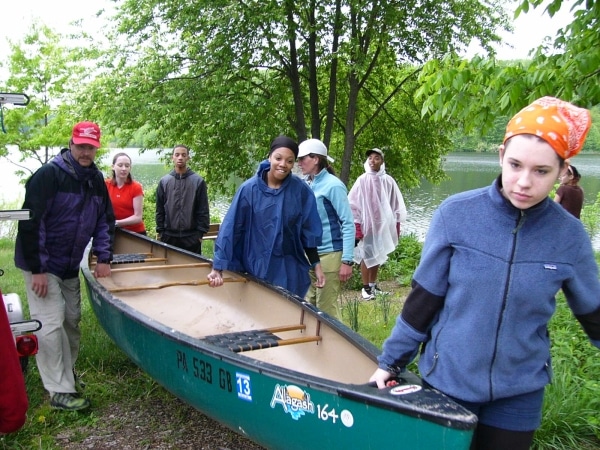 Brandywine Trek students carrying a canoe.