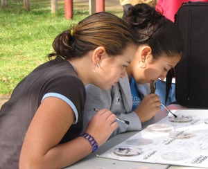 Two students perform a leaf pack experiment in Oregon.