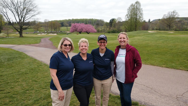 Four golf outing volunteers from Resolution Life.