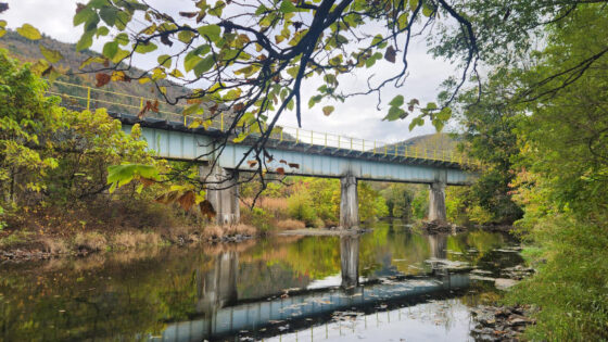 A bridge is reflected in Aquashicola Creek.