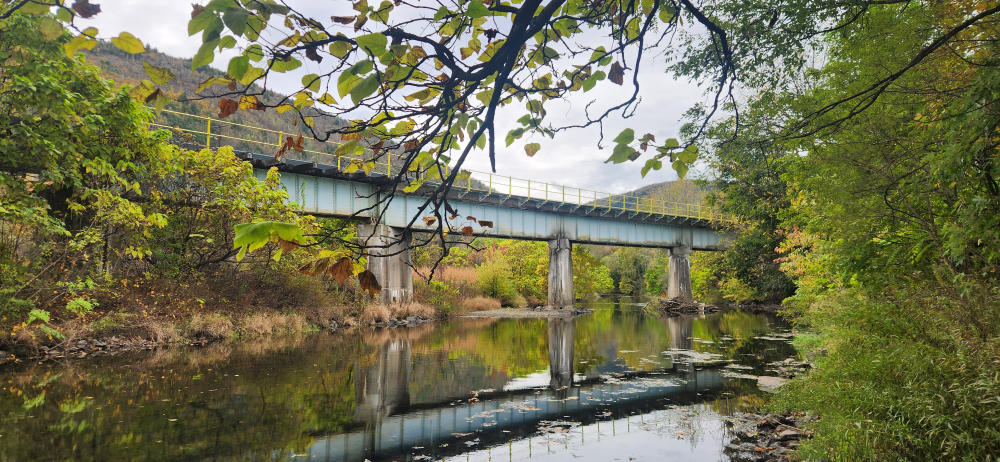A bridge is reflected in Aquashicola Creek.