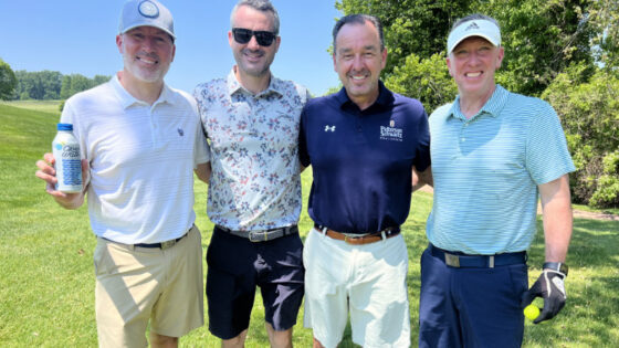 Golfers with water donated by Open Water.
