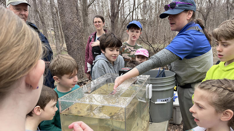 A scientist explains electrofishing at World Water Day.