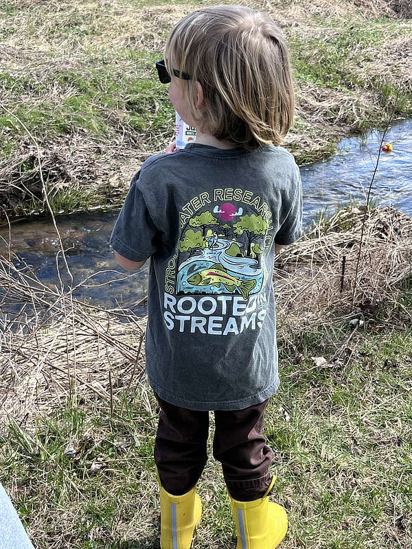 A child watches the rubber duckie race in White Clay Creek.