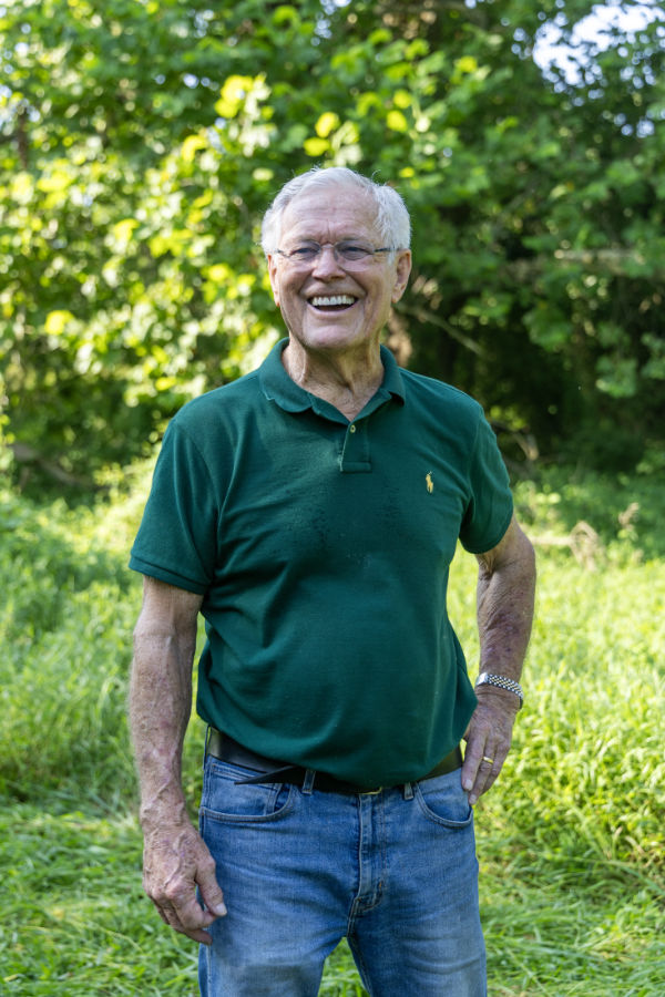 Coach Dick Vermeil stands in his streamside forest.