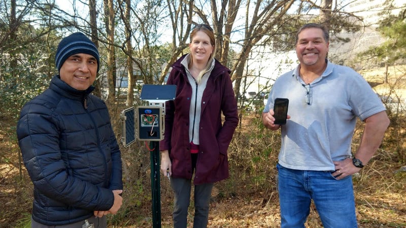 Left to right: Santosh Ghimire, Ph.D., Shannon Hicks, and Kurt Wolfe, displaying a Mayfly Data Logger-based rooftop rainwater monitoring device installed at the EPA Office of Research and Development in Athens, Ga.