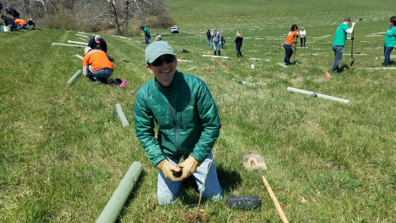 Scott Ensign planting trees on the Vermeil property.