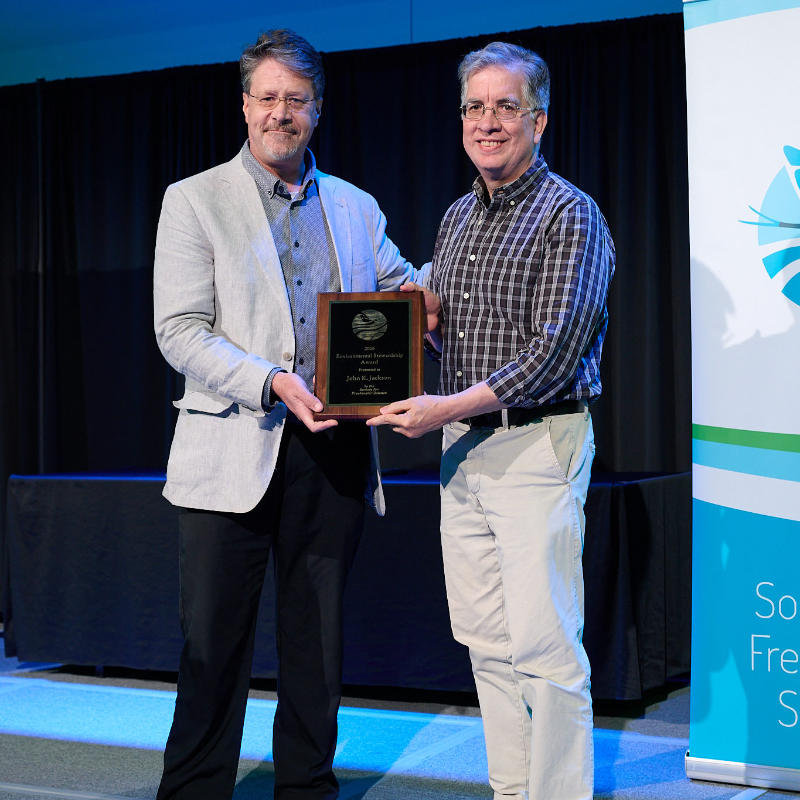Dave Arscott presents the 2026 SFS Environmental Stewardship Award to John Jackson. Photo: Morton Visuals