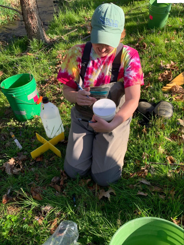 Labeling macroinvertebrate samples streamside.