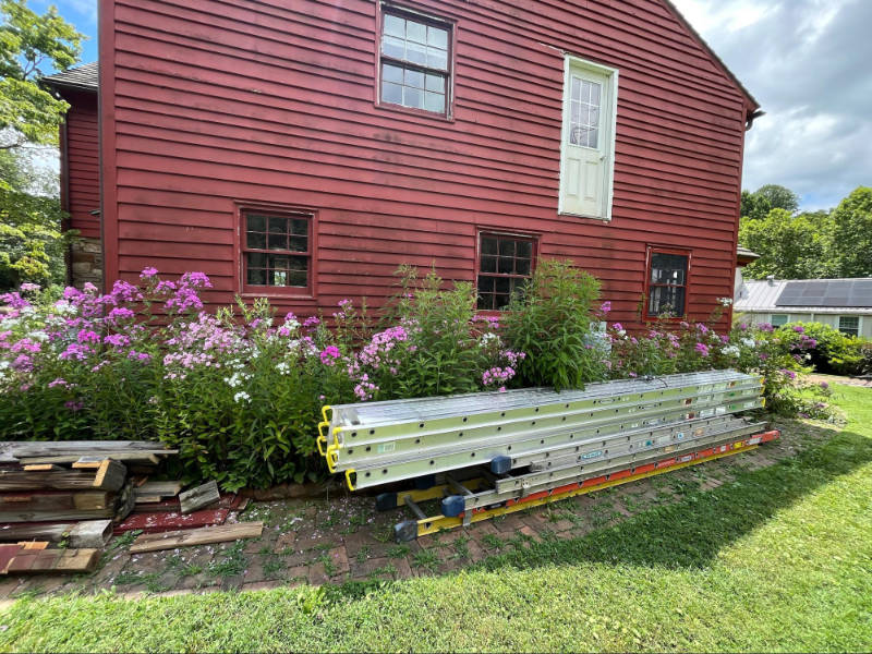 Ladders stacked outside the historic cabin.