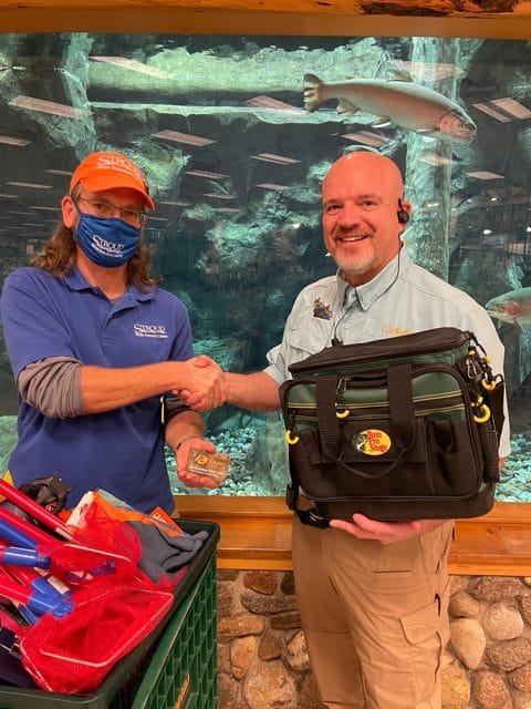 Stroud Center and Cabela's staff member with donated gear.