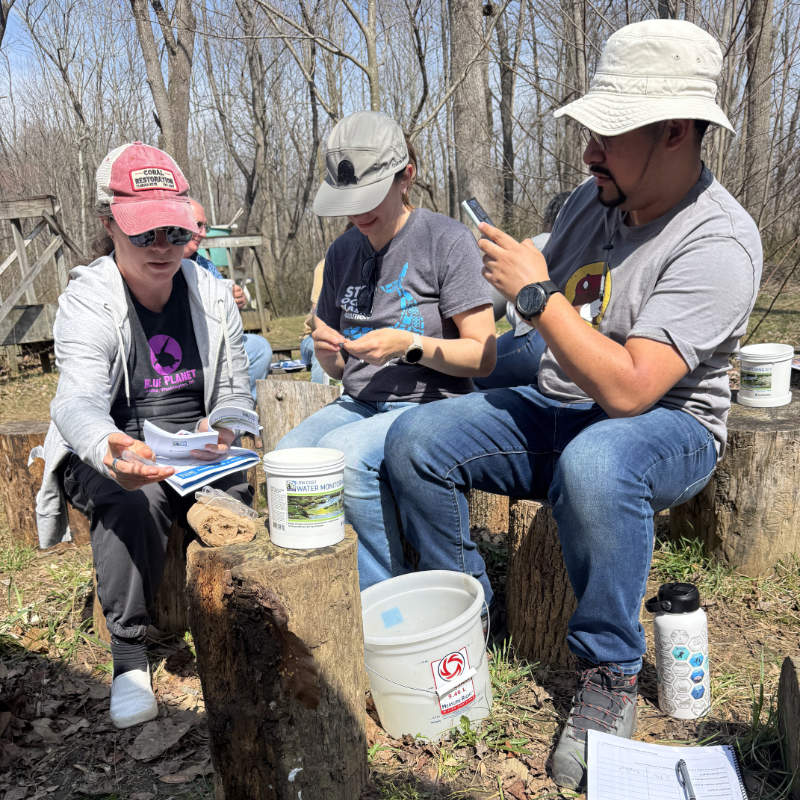 Teachers perform water chemistry tests at a workshop.
