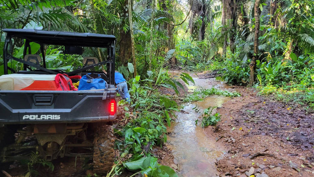 A four-wheel drive vehicle navigates difficult terrain in Belize.