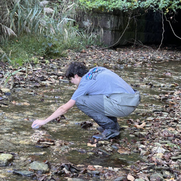 Valley Forge Trout Unlimited volunteer taking a fall salt snapshot sample.
