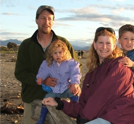 David Arscott with his wife and children on a New Zealand beach.