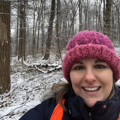 Betsy Kerlin in a snowy forest.