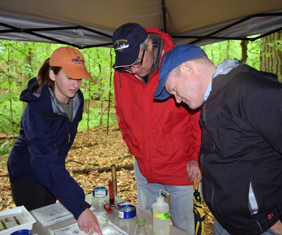 Maria Scarborough with U.S. Sens. Chris Coons and Sheldon Whitehouse at the Stroud Center table at a bioblitz.