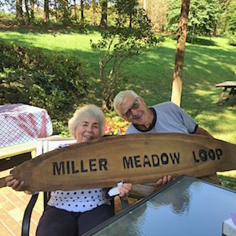 Bud and Marilyn Miller holding their Miller Meadow Loop sign.
