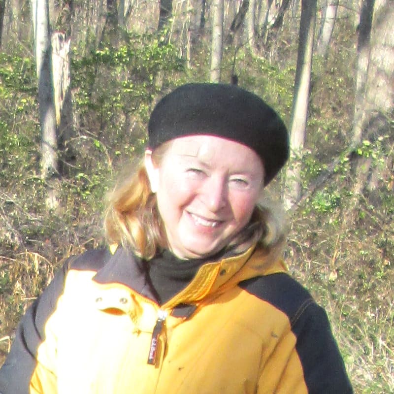 Headshot of Carol Armstrong, Ph.D., in a riparian forested buffer.