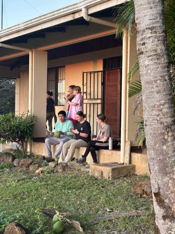 College students relax on a porch at Maritza Biological Station, Costa Rica.
