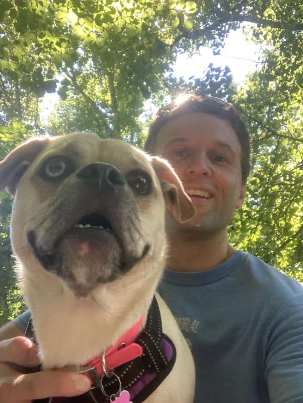 Daniel Myers and his dog in a close-up.