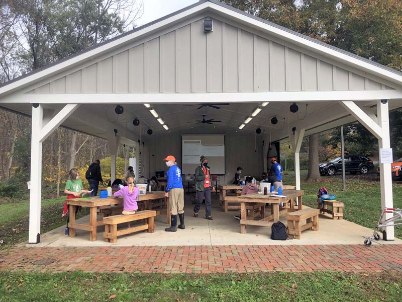 Stroud Water Research Center's education pavilion, with elementary students performing water chemistry tests.