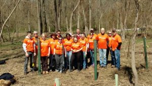 Exelon volunteers pose for a group photo at a tree planting event.