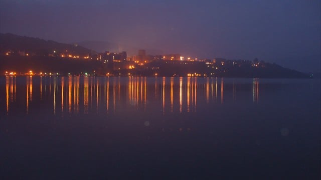 Lights from a town reflect off the Hudson River.