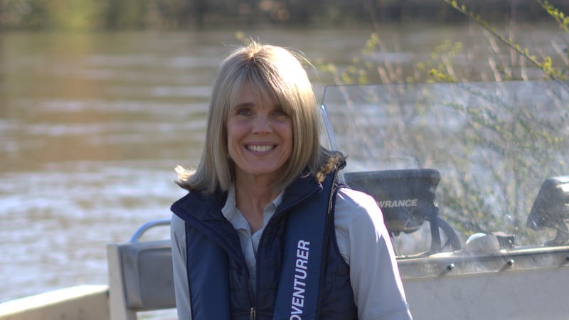 Laura Turner Seydel in a boat with water in the background.