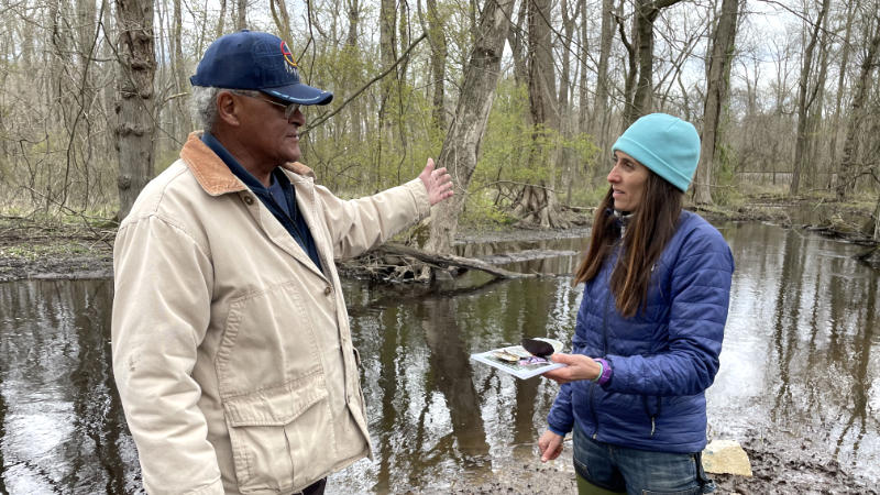 Lenape Chief Dennis Coker discussing native mussels with Tara Muenz along Fork Branch in Delaware.