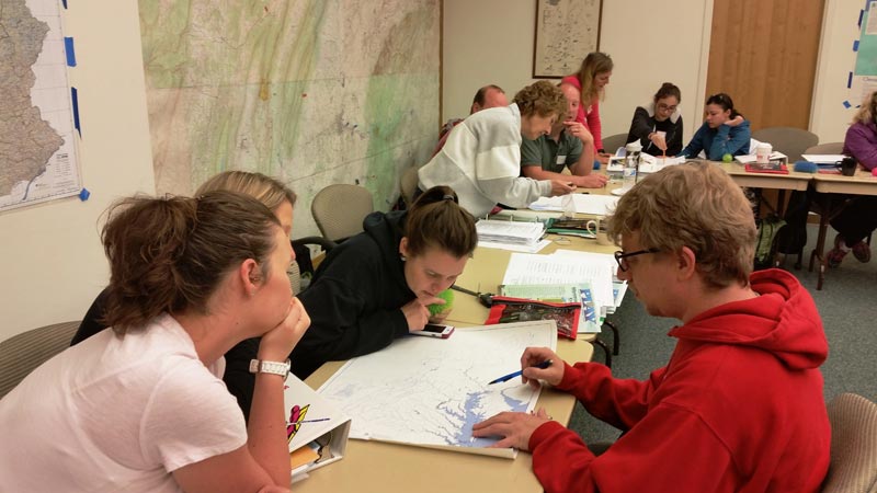 People looking at a watershed map