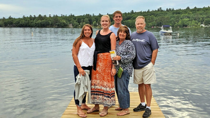 Kristen McCarthy with her family on a lakeside dock in Maine.