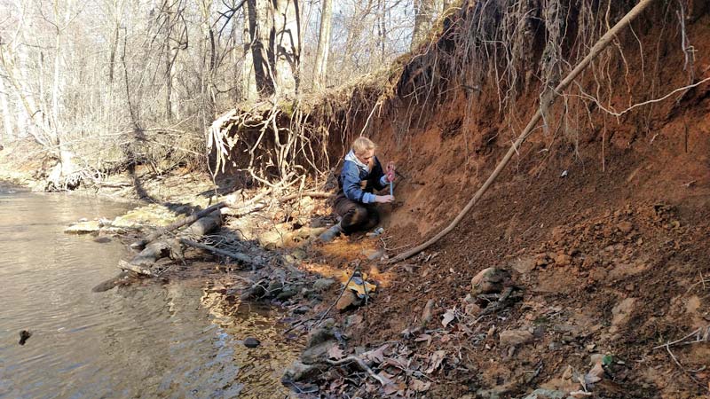 Kristen McCarthy measuring streambank erosion along White Clay Creek.