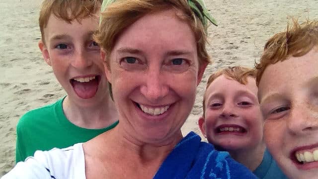 Jen Merrill with her three sons on the beach.