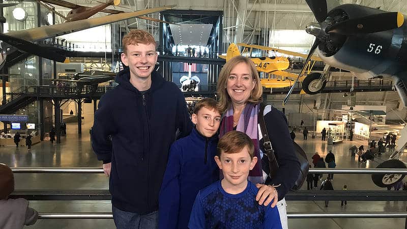 Jen Merrill and her three sons at an aircraft museum.