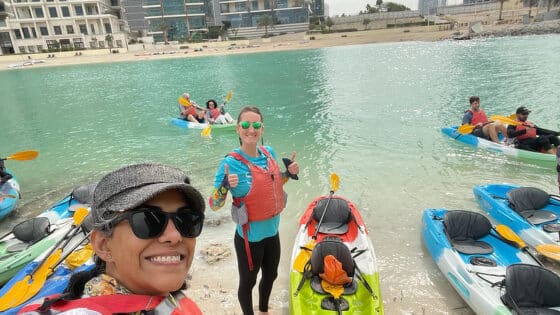 Two women gear up for kayaking on a waterway in Dubai.