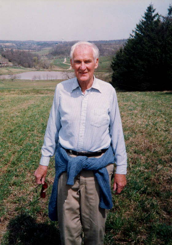 Dr. Morris W. Stroud standing in a field at Georgia Farm.