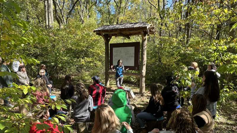 Tara Muenz and a group of Hillendale Elementary School teachers in an outdoor classroom.