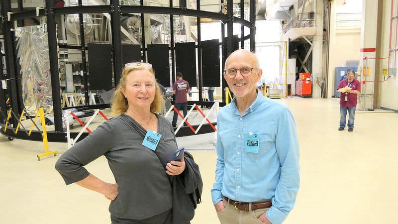 Carol Armstrong and Dave Manning stand outside a space conditions simulator.