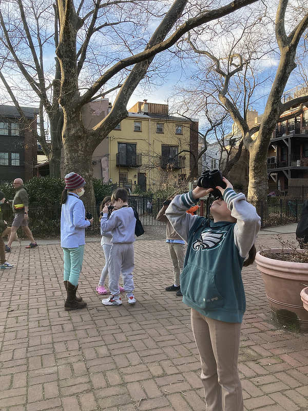 Elementary schools students use binoculars to look for birds in Philadelphia.
