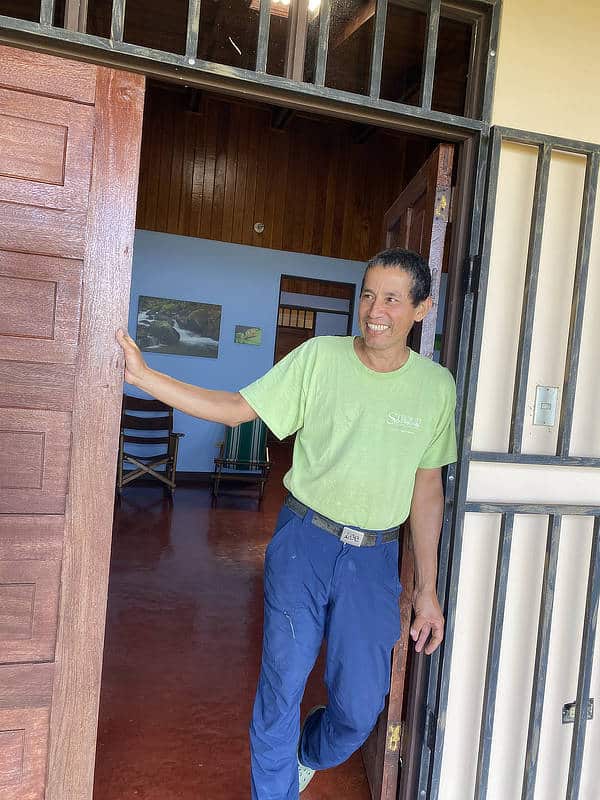 A man stands in the doorway of a guesthouse in Costa Rica.