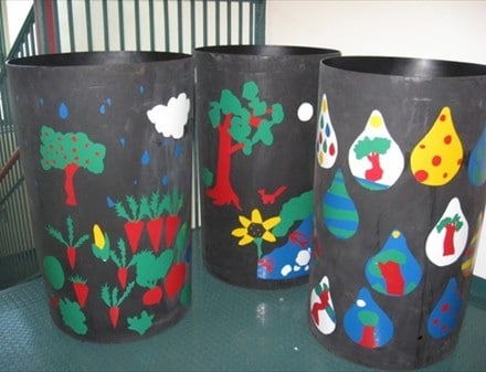 Three rain barrels painted with bright images.