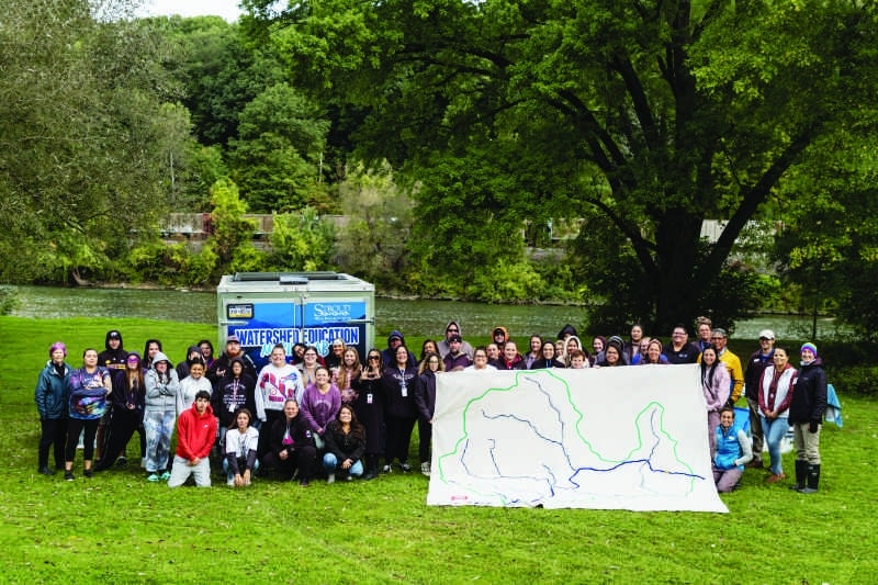 Seneca Arts and Learning Center staff with a large watershed map.