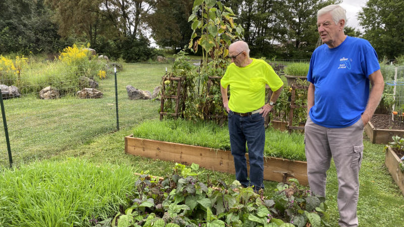 Don Ace and Max Stoner look over their raised beds with cover crops.