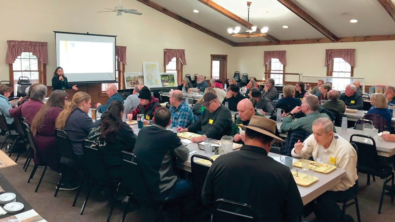 Farmers, landowners, and community members learn about forest buffers and soil health at a workshop.