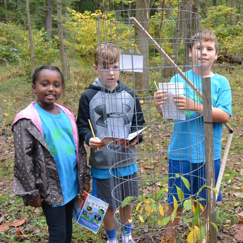 Middle school students explore the local watershed to complete their field note books.