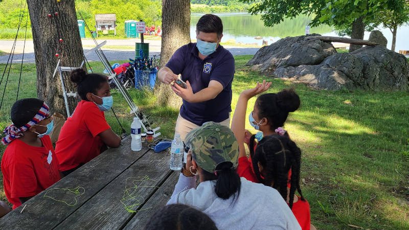 Youths in park learning how to fish.