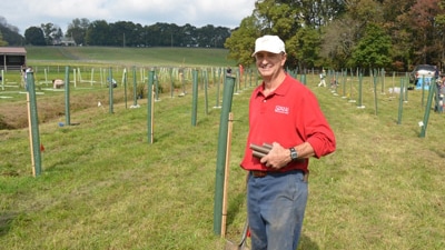 Bern Sweeney standing in a newly planted riparian forest buffer.