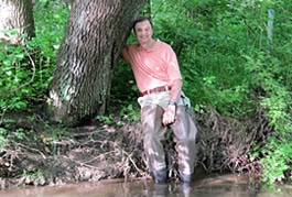 Bern Sweeney leans against a tree on the banks of White Clay Creek.